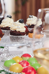 Sweet catering. Desserts and chocolate muffins on the festive table. Close-up