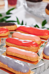 Assorted eclairs on the festive table. Catering. Close-up