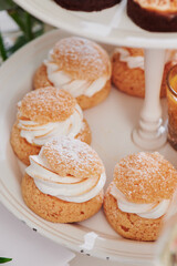 Profiteroles on the festive table. Sweet catering. Assorted desserts. Close-up