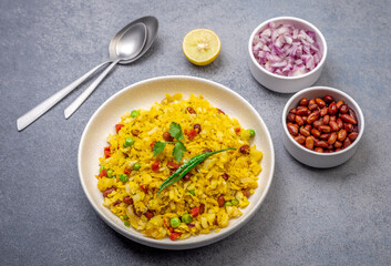 spicy Indian snack or breakfast  poha with onion and peanuts