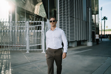 Confident businessman walking down street