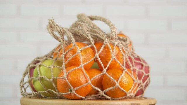 Plastic free kitchen with fruits. Fruit in a string bag. Eco fruits in an eco bag. Zero waste.