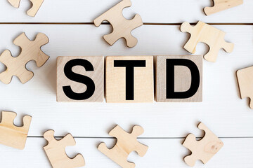 Obraz premium STD . on wooden cubes on a white background. wood puzzles