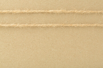 Jute twine on brown craft paper background. 