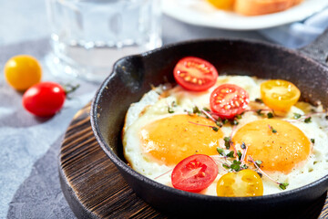 Fried eggs in cast-iron skillets. Sunny morning breakfast concept