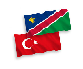 National vector fabric wave flags of Turkey and Republic of Namibia isolated on white background. 1 to 2 proportion.