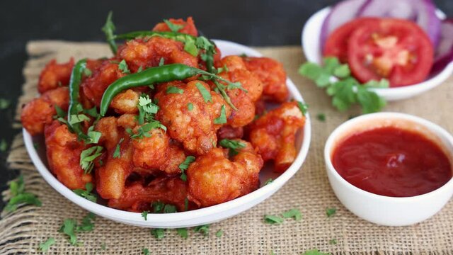 Gobi Manchurian dry, Gobi 65 popular Indian street food snack Delhi Mumbai India made cauliflower florets Veg Manchurian chilly gobi 4K slow motion footage video Indo Chinese side dish chapati roti 
