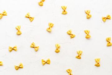 Italian colorful pasta pattern, top view. Various vegan farfalle pasta