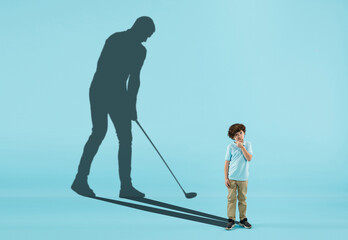 Childhood and dream about big and famous future. Conceptual image with boy and shadow of sportive male golf player, champion on blue background. Dreams, imagination, education concept.