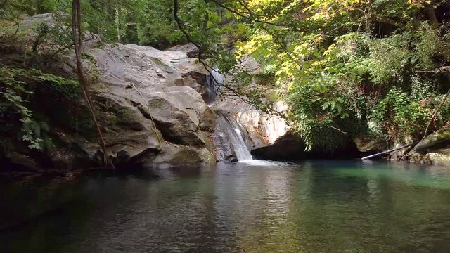 Hidden Waterfall  in the Forest with a Natural Pool For Swimming in the Mountains during summer