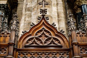 Gothic architecture. Cross on a wooden base with patterns. Prayer booth.