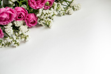 white dried flowers statice and rose raspberry peony on a white background . space for text