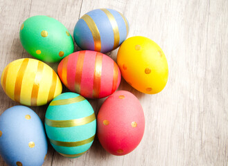 Fototapeta na wymiar Colorful handmade painted easter eggs on a wood background