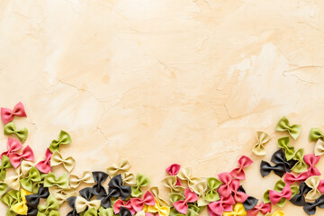 Heap of colored farfalle pasta, top view