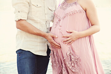 A pregnant couple with nice dresses