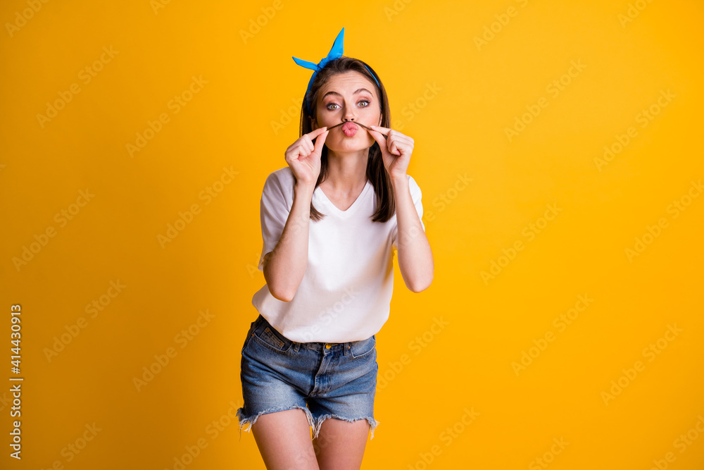 Sticker photo portrait of playful girl wearing headband keeping mustache on plump pouted lips isolated on br