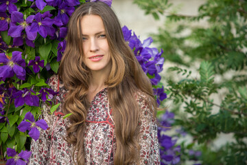 Beautiful woman with long hair in spring purple flowers background