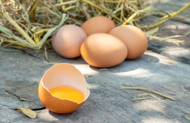 Fresh raw eggs and yolks on the wooden floor