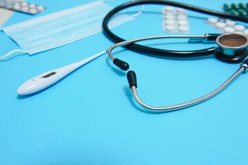 colorful tablets and capsules in a box, thermometer, statoscope, antiseptic bottle, container,...