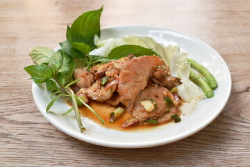 spicy roasted pork Thai salad eat with fresh basil leaf and cabbage on plate
