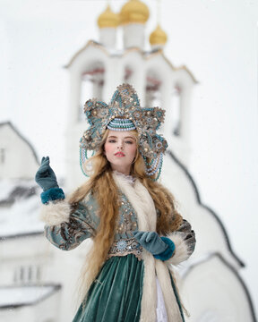 A Girl In National Russian Dress Against The Background Of A Church With Golden Domes