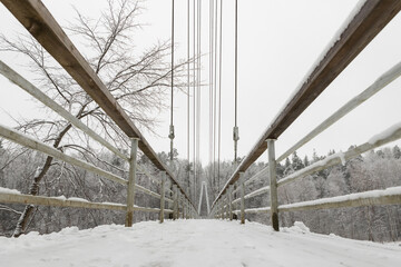 Kājnieku tilts pār Gauju Gauja river bridge over winter snow covered trees frozen 