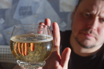 The man refuses the offered champagne wine in a glass