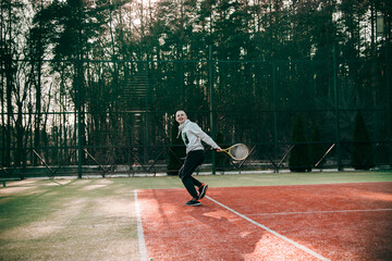 young guy playing tennis