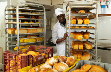 African-american lay out over trolley fresh pastries. High quality photo