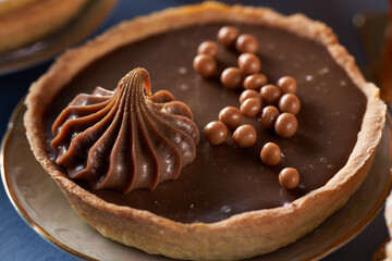 Chocolate tart on blue background