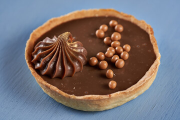 Chocolate tart on blue background