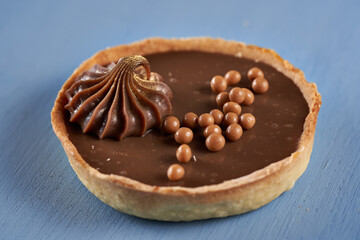 Chocolate tart on blue background