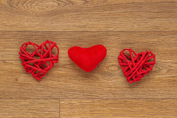 red paper  hearts on wooden background