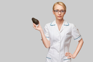 nutritionist doctor healthy lifestyle concept - holding organic avocado fruit