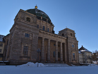 Fototapeta na wymiar Front view of famous Saint Blaise Cathedral (Dom) of St. Blasien, Germany, part of the Benedictine Monastery, in winter season in the Black Forest hills with snow on sunny day.