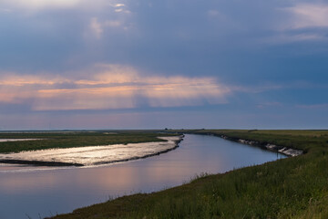 View of Langwarder Groden / Germany in the early evening with the onset of the tide