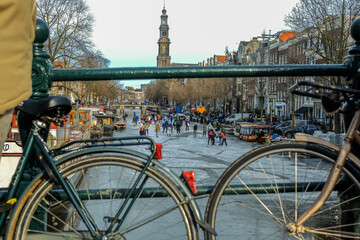 Fototapeta premium People ice scating on frozen canal in city center of Amsterdam