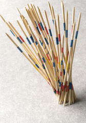 Vertical shot of mikado game sticks on a white background