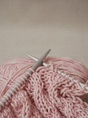 home hobbies, cozy knitted sweaters with a ball of yarn in the living room on a wooden background