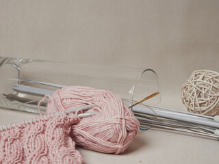 home hobbies, cozy knitted sweaters with a ball of yarn in the living room on a wooden background