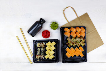 Japanese food delivery. Big sushi set in plastic box.