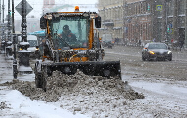 Snow removal with the help of equipment on the city street in a blizzard, Nevsky Prospekt, St. Petersburg, Russia, February 2021