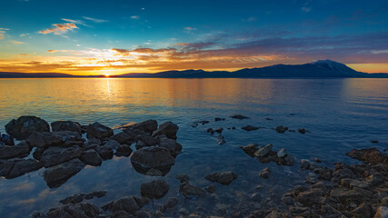 lake with mountain in the background, sunset