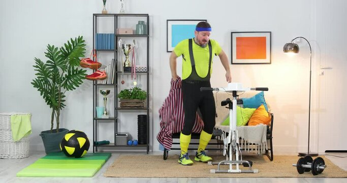 Fitness parody. Humor in sports. Expressive fitness guy doing fake training at home