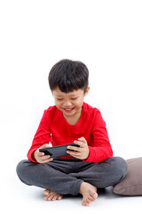 Happy little Asian boy using a smartphone at home, isolated on white background.