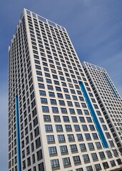 Fototapeta na wymiar High-rise residential building on a background of blue sky