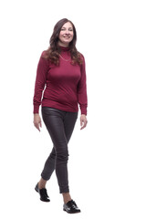 in full growth. happy young woman striding forward