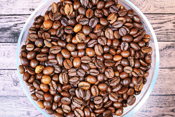 Brown coffee beans lie on the plate