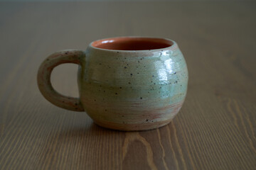 Pottery, a ceramic product with your own hands, made on a potter's wheel, a teapot, a mug.