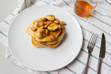 Pancakes with honey and banana on a plate. Banana pancake. Healthy food. Ketogenic diet.